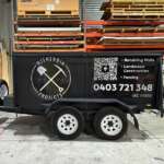 Printed vinyl decals as trailer advertising for garden and outdoor construction projects, featuring QR Codes that link to personalised Linktree landing sites on the Internet - passenger side.
